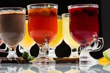 Image showing mulled wine. fruit or berry drink. alcohol winter. against a dark background
