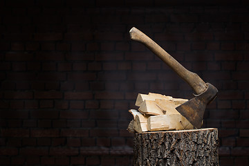 Image showing birch firewood, old rusty ax 