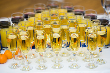 Image showing Glasses with champagne on the party table. lot of alcohol