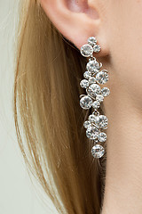 Image showing close up of woman wearing shiny diamond earrings