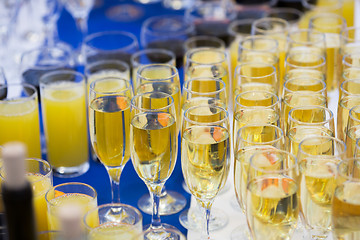 Image showing Glasses with champagne on the party table. lot of alcohol