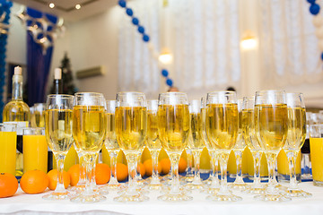 Image showing Glasses with champagne on the party table. lot of alcohol