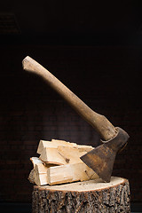 Image showing birch firewood, old rusty ax 