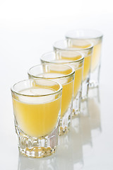 Image showing Beautiful shot glasses back lit. yellow