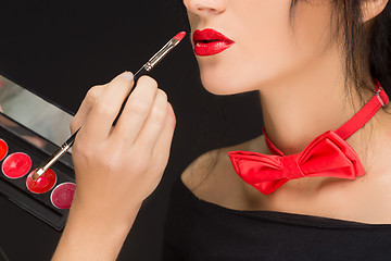 Image showing Lips of a girl with artist doing makeup