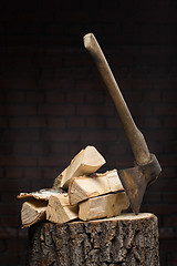 Image showing birch firewood, old rusty ax 