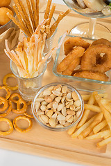 Image showing set of different salty snacks. 