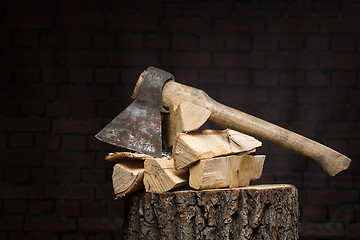 Image showing birch firewood, old rusty ax 