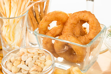 Image showing set of different salty snacks. 