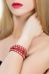 Image showing hands close-up of a young girl with leather bracelet