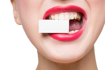 Image showing girl holds in teeth white form. isolated