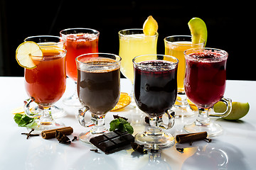 Image showing mulled wine. fruit or berry drink. alcohol winter. against a dark background
