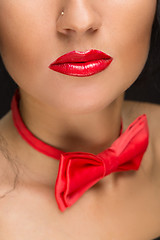 Image showing close-up of bright red lips, tied around his neck the bow tie