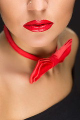 Image showing close-up of bright red lips, tied around his neck the bow tie