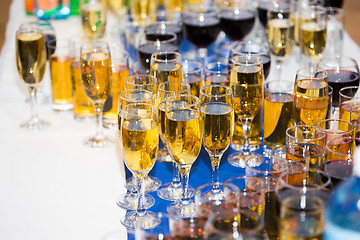 Image showing Glasses with champagne on the party table. lot of alcohol