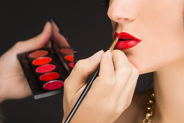 Image showing Lips of a girl with artist doing makeup