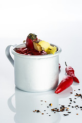 Image showing bloody mary cocktail in the iron circle on a white background