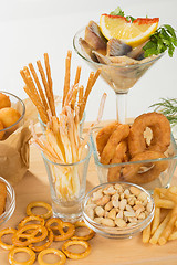 Image showing set of different salty snacks. 