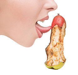 Image showing girl touching tongue to bits of pear-like dildo