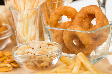 Image showing set of different salty snacks. 