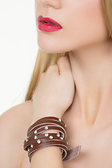 Image showing hands close-up of a young girl with leather bracelet