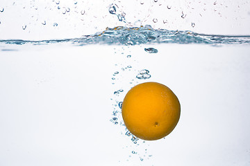 Image showing orange splash in water 