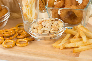 Image showing set of different salty snacks. 