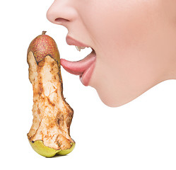 Image showing girl touching tongue to bits of pear-like dildo