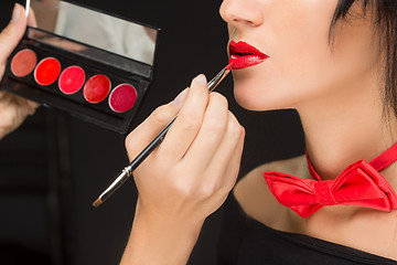 Image showing Lips of a girl with artist doing makeup