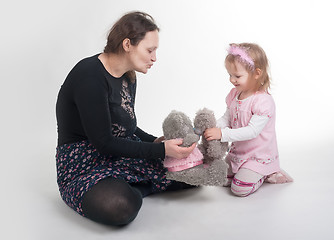 Image showing Mother explains to daughter a kiss on toys