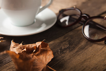 Image showing Glasses and cup of coffee on a wooden table