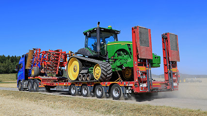 Image showing Volvo FH Hauls John Deere Tractor