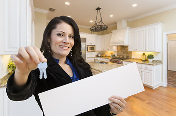 Image showing Hispanic Woman In Kitchen Holding House Keys and Blank Sign