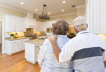 Image showing Senior Couple Looking Over Beautiful Custom Kitchen