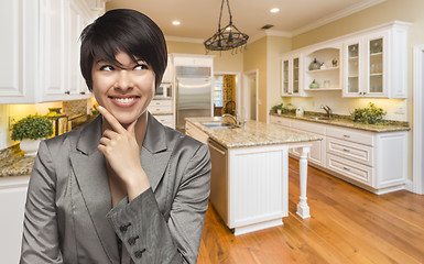 Image showing Mixed Race Woman Looking Back Over Shoulder Inside Custom Kitche