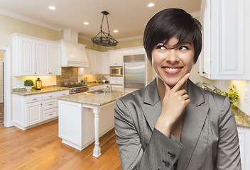 Image showing Mixed Race Woman Looking Back Over Shoulder Inside Custom Kitche