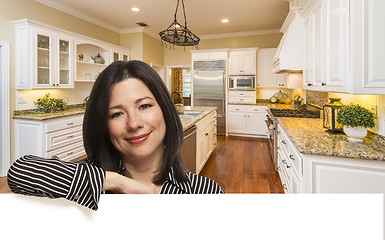 Image showing Hispanic Woman Leaning Against White In Custom Kitchen Interior