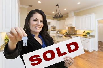 Image showing Hispanic Woman In Kitchen Holding House Keys and Sold Sign