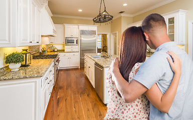 Image showing Young Hopeful Military Couple Looking At Custom Kitchen