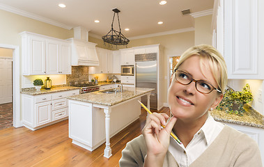 Image showing Daydreaming Woman with Pencil Inside Beautiful Custom Kitchen