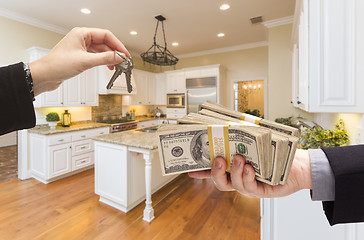 Image showing Handing Over Cash for Keys Inside Beautiful Kitchen