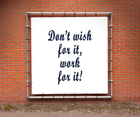 Image showing Large banner with inspirational quote on a brick wall