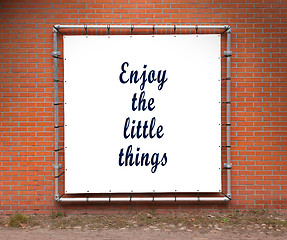 Image showing Large banner with inspirational quote on a brick wall