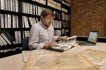 Image showing Researcher in Archive Examining Maps and Other Archival Material