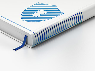 Image showing Security concept: closed book, Shield With Keyhole on white background