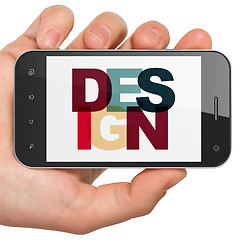 Image showing Marketing concept: Hand Holding Smartphone with Design on  display