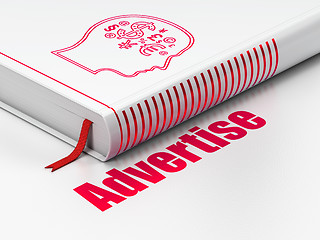 Image showing Advertising concept: book Head With Finance Symbol, Advertise on white background