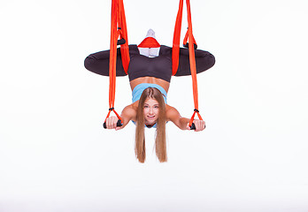 Image showing Young woman doing anti-gravity aerial yoga in hammock