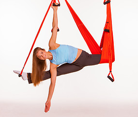 Image showing Young woman doing anti-gravity aerial yoga in hammock