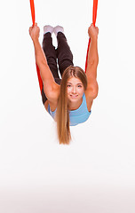 Image showing Young woman doing anti-gravity aerial yoga in hammock